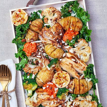 Hasselback potatoes with roasted vegetables, chicken, and grilled pepper cream